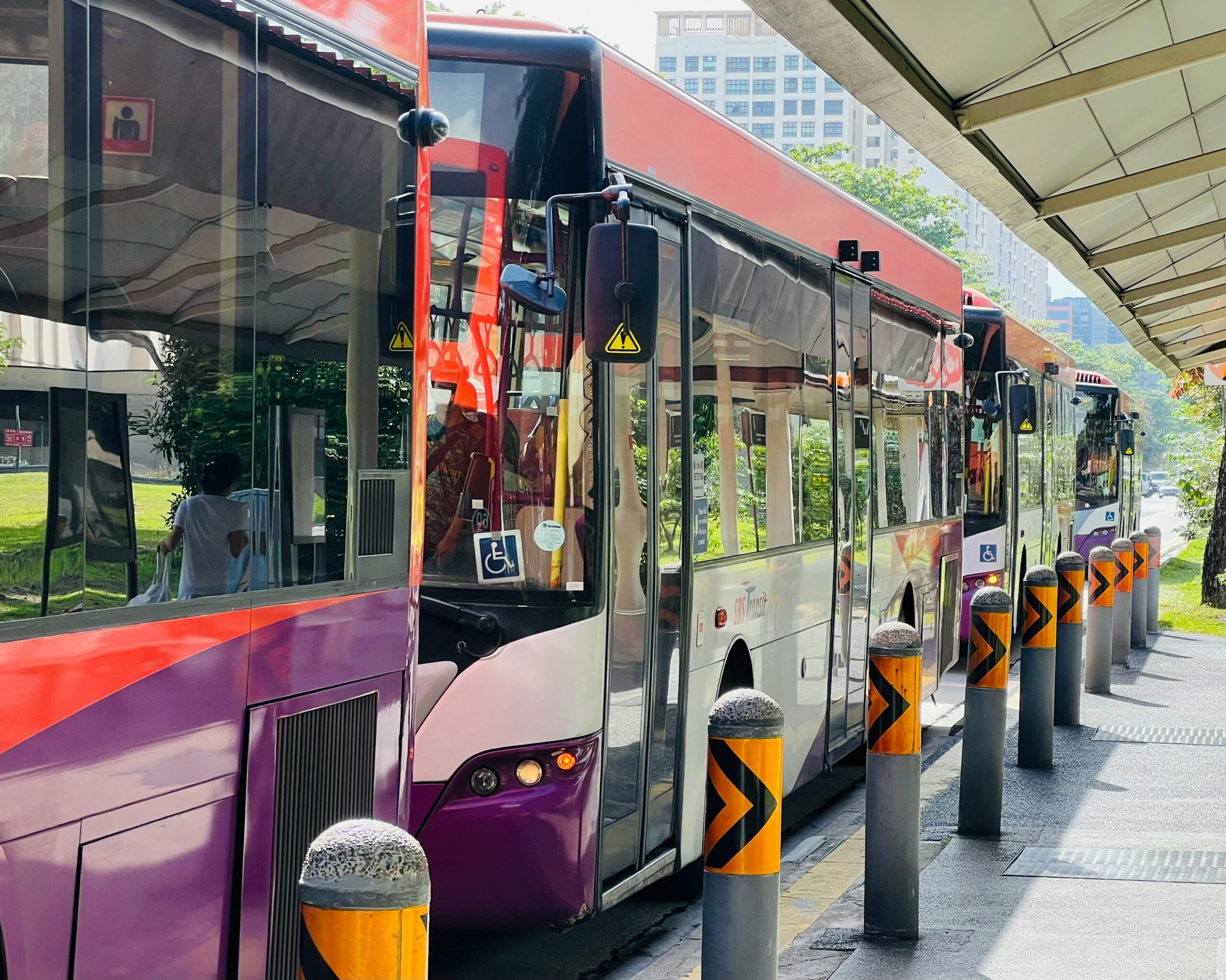 Singapore bus ETA system data flow from GNSS satellites and NTP time server to bus on-board units, central servers and passenger information displays